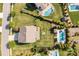 Expansive backyard features lush green grass, mature trees, an outdoor fireplace, and an in-ground pool with a cabana at 7693 Lazy Hollow Ln, Denver, NC 28037