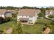 Well-maintained backyard features a covered patio with outdoor seating and a lush lawn at 7693 Lazy Hollow Ln, Denver, NC 28037