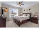 Cozy bedroom with a large window, ceiling fan, and comfortable furnishings at 7693 Lazy Hollow Ln, Denver, NC 28037