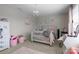 Cozy bedroom with a white bed frame and pink accents at 7693 Lazy Hollow Ln, Denver, NC 28037