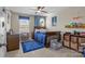 bedroom with hardwood bed frame, blue rug and round window at 7693 Lazy Hollow Ln, Denver, NC 28037