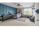 Bedroom featuring a blue paneled wall, study desk and a fan at 7693 Lazy Hollow Ln, Denver, NC 28037
