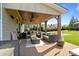 Inviting covered patio with brick flooring, ceiling fans, and comfortable outdoor seating area at 7693 Lazy Hollow Ln, Denver, NC 28037