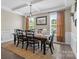 Formal dining room with coffered ceilings, wainscoting, and chandelier lighting above at 7693 Lazy Hollow Ln, Denver, NC 28037