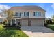 Beautiful two-story home with brick accents, a two-car garage and landscaped front yard at 7693 Lazy Hollow Ln, Denver, NC 28037