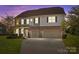 Beautiful two-story home with brick accents, a two-car garage and landscaped front yard at 7693 Lazy Hollow Ln, Denver, NC 28037