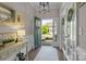 Charming foyer featuring hardwood floors, decorative accents, a statement mirror and French doors at 7693 Lazy Hollow Ln, Denver, NC 28037