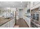 Stylish kitchen featuring white cabinets, granite countertops, and stainless steel appliances at 7693 Lazy Hollow Ln, Denver, NC 28037