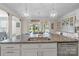Open-concept kitchen features a large island, stainless steel appliances, and modern pendant lighting at 7693 Lazy Hollow Ln, Denver, NC 28037