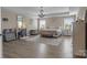 Spacious primary bedroom with a tray ceiling, chandelier, and neutral decor at 7693 Lazy Hollow Ln, Denver, NC 28037