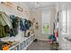 Mudroom with built-in storage, bench, and window at 7693 Lazy Hollow Ln, Denver, NC 28037