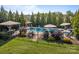 Beautiful in-ground pool features a tanning ledge and water features and is surrounded by mature landscaping at 7693 Lazy Hollow Ln, Denver, NC 28037