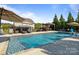 Beautiful in-ground pool features a tanning ledge and water features and is surrounded by mature landscaping at 7693 Lazy Hollow Ln, Denver, NC 28037