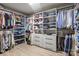Organized walk-in closet with custom shelving and hanging racks for ample storage at 7693 Lazy Hollow Ln, Denver, NC 28037
