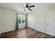 Bedroom features a window with curtains, closet, and wood-look flooring at 773 Sir Raleigh Dr, Concord, NC 28025