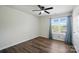 Bright bedroom features a ceiling fan, window with curtains, plus wood-look flooring at 773 Sir Raleigh Dr, Concord, NC 28025