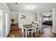 Charming dining area showcasing a dark-wood table and white chairs, with entry to living room and stairs at 773 Sir Raleigh Dr, Concord, NC 28025