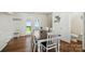 Bright dining room boasts hardwood floors, neutral paint, and a classic farmhouse table, seating six guests at 773 Sir Raleigh Dr, Concord, NC 28025
