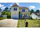 Charming two-story home with attached garage, landscaped front yard and front porch at 773 Sir Raleigh Dr, Concord, NC 28025