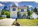 Well-maintained two-story home with garage, landscaping and front porch seating area at 773 Sir Raleigh Dr, Concord, NC 28025