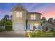 Inviting two-story home featuring a charming front porch and attached garage at 773 Sir Raleigh Dr, Concord, NC 28025