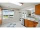 Cozy kitchen area with oak cabinets, stainless-steel dishwasher, granite counters and a checkered-tile floor at 773 Sir Raleigh Dr, Concord, NC 28025