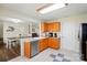 Updated kitchen showcasing oak cabinetry, granite countertops, and stainless-steel dishwasher and sink at 773 Sir Raleigh Dr, Concord, NC 28025