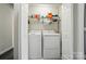 Inside a closet features a stacked washer and dryer and a wire shelf at 773 Sir Raleigh Dr, Concord, NC 28025