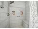 Updated walk-in shower with designer tiles, a built-in bench, and modern shower fixtures at 773 Sir Raleigh Dr, Concord, NC 28025