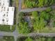 An aerial view of a property surrounded by mature trees in a neighborhood with easy access to the main roads and facilities at 8475 Nc 49 N Hwy, Mount Pleasant, NC 28124