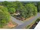 An aerial shot of a fenced in property surrounded by mature trees and convenient access to nearby roads for easy commuting at 8475 Nc 49 N Hwy, Mount Pleasant, NC 28124
