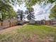 Fenced in backyard with green grass, a wooden fence, and a storage shed at 8475 Nc 49 N Hwy, Mount Pleasant, NC 28124