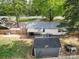 Charming backyard features a cozy deck, shed, and privacy fence, perfect for outdoor relaxation and entertaining in a private setting at 8475 Nc 49 N Hwy, Mount Pleasant, NC 28124