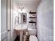 Bathroom featuring a stylish shower curtain, pedestal sink, neutral paint, and decorative floating shelves at 8475 Nc 49 N Hwy, Mount Pleasant, NC 28124