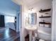 Cozy bathroom with pedestal sink, updated fixtures, floating shelves, and decorative accents at 8475 Nc 49 N Hwy, Mount Pleasant, NC 28124