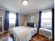 Bright bedroom features hardwood floors, fresh paint, and two windows at 8475 Nc 49 N Hwy, Mount Pleasant, NC 28124