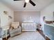 Cozy Bedroom with gray walls, wood floors, a white crib, and stuffed animals at 8475 Nc 49 N Hwy, Mount Pleasant, NC 28124