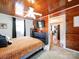 Primary bedroom with wood plank ceiling, natural light, carpet floors, and flows into the living room at 8475 Nc 49 N Hwy, Mount Pleasant, NC 28124