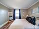 Well-lit bedroom with hardwood floors, fresh paint, window and large mirror at 8475 Nc 49 N Hwy, Mount Pleasant, NC 28124
