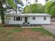 Charming single-story home featuring a metal roof, white siding, and well-manicured front lawn at 8475 Nc 49 N Hwy, Mount Pleasant, NC 28124