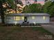 Charming single-story home featuring a metal roof, white siding, and well-manicured front lawn at 8475 Nc 49 N Hwy, Mount Pleasant, NC 28124