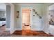 Hallway view into the bathroom with gray walls and hardwood floors leading into another bedroom at 8475 Nc 49 N Hwy, Mount Pleasant, NC 28124