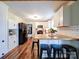 Modern kitchen featuring white cabinets, stainless steel appliances, and a butcher block countertop with bar seating at 8475 Nc 49 N Hwy, Mount Pleasant, NC 28124