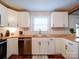 Well-lit kitchen with stainless steel appliances, butcher block counters, and bright white cabinetry and subway tile at 8475 Nc 49 N Hwy, Mount Pleasant, NC 28124