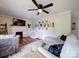 Comfortable living room boasts a sectional sofa, fireplace, and modern decor with a ceiling fan at 8475 Nc 49 N Hwy, Mount Pleasant, NC 28124