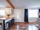 Open floor plan connects living room to the kitchen with wood floors, offering a bright, welcoming atmosphere at 8475 Nc 49 N Hwy, Mount Pleasant, NC 28124