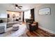 Charming living room showcases wood-look floors, a neutral sofa, and a seamless transition to the kitchen at 8475 Nc 49 N Hwy, Mount Pleasant, NC 28124
