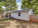 View of the back of the home with white siding, a deck, grill, and fenced-in yard at 8475 Nc 49 N Hwy, Mount Pleasant, NC 28124