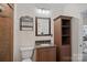 Traditional bathroom with a brown cabinet, granite countertop, mirror, and a shower with light beige tiles at 8651 Walsham Dr, Charlotte, NC 28277