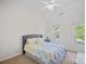 Bright bedroom features a comfortable bed, ceiling fan, and natural light from two windows at 8651 Walsham Dr, Charlotte, NC 28277